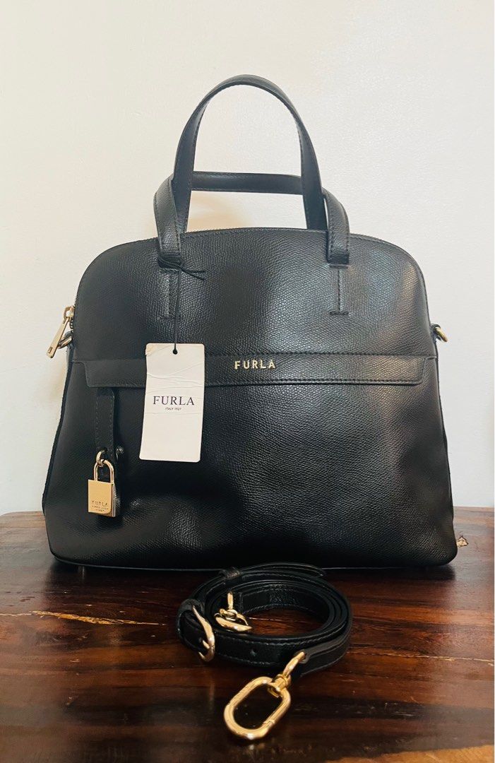 Furla Piper Medium Dome Bag (Category: Luxury Bags & Wallets) located in Iloilo. Submitted by yangfire (Listing ID 1332861399, Image 1). Description: The Furla Piper Medium Dome in Nero encapsulates sophistication and versatility in a single accessory. Its sleek silhouette and timeless black hue make it a timeless addition to any wardrobe, seamlessly complementing both casual and formal looks. Crafted with precision and attention to detail, this 