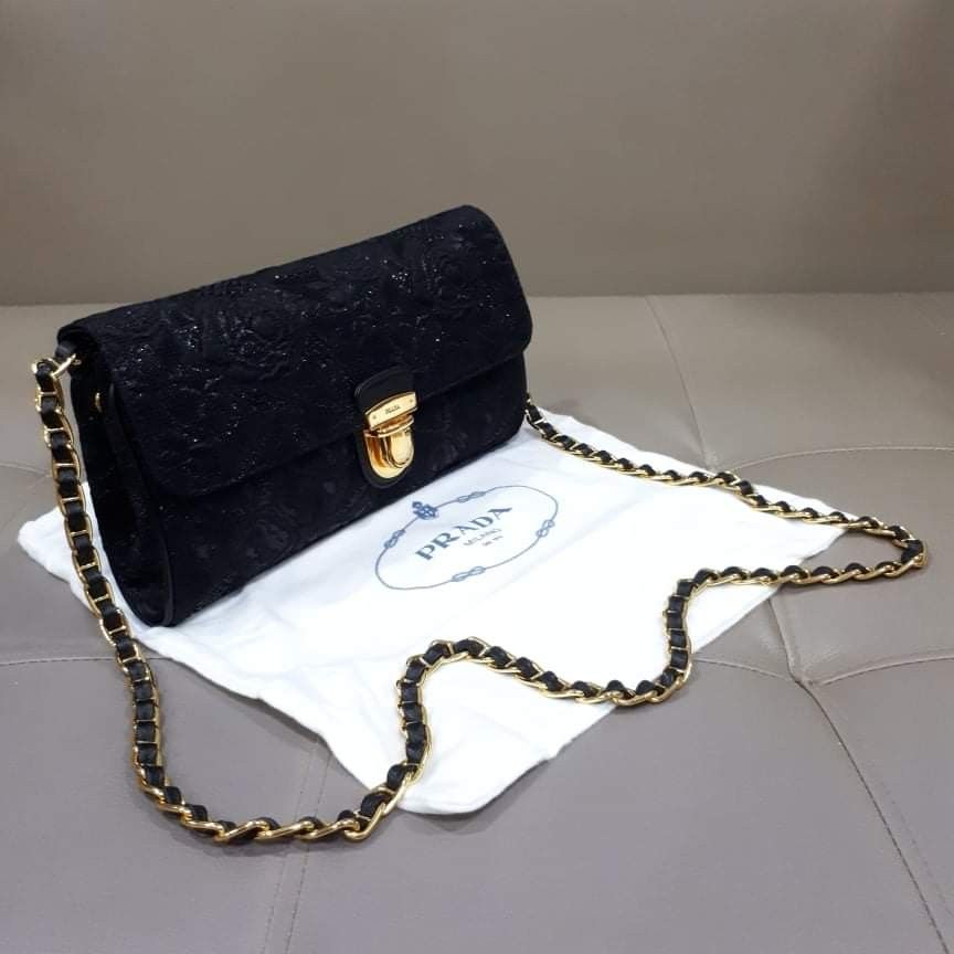 Prada Pattina Tessuto Lurex Nero (Category: Luxury Bags & Wallets) located in Taguig. Submitted by esa.agustin (Listing ID 1332859369, Image 2). Description: Original Prada Pattina Lurex Nero chain sling bag. Complete inclusion (box, dust bag, carecard and authenticity card). Gold chain and hardware. Made in Italy..