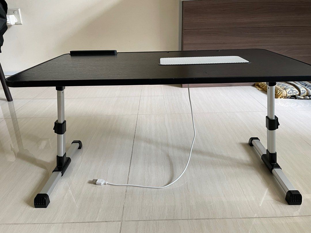 Adjustable mini table (Category: Tables & Sets) located in Singapore. Submitted by bevvvvvlyyy (Listing ID 1333033767, Image 1). Description: Bought it a few months ago. Lightly used. Adjustable mini table - can be put on bed or on a bigger table. Dimensions: 60cm x 34cm Height: 24 cm, can be adjusted to 32cm Table can be folded as shown. USB port that comes along with it. .