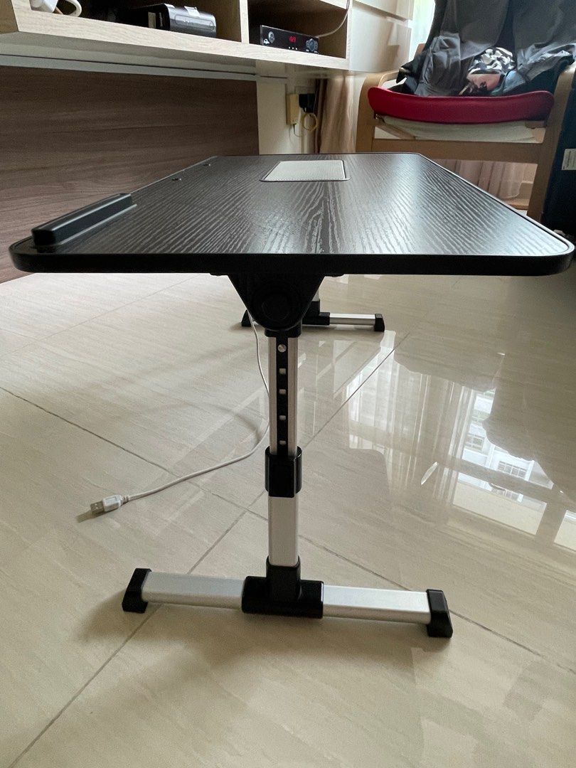 Adjustable mini table (Category: Tables & Sets) located in Singapore. Submitted by bevvvvvlyyy (Listing ID 1333033767, Image 3). Description: Bought it a few months ago. Lightly used. Adjustable mini table - can be put on bed or on a bigger table. Dimensions: 60cm x 34cm Height: 24 cm, can be adjusted to 32cm Table can be folded as shown. USB port that comes along with it. .