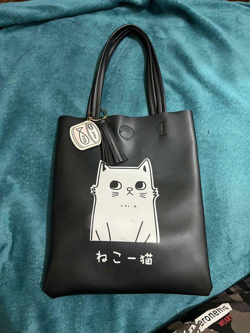 Cat Faux Leather Tote Bag (Category: Tote Bags) located in Dagupan City. Submitted by fonsomatthy (Listing ID 1332998174, Image 1). Description: ‼️FOR SALE!‼️ ✅Cat Faux Leather Tote Bag 👉🏻Helping a friend ✅ With minimal signs of usage as seen sa pic. Has one magnetic closure. Keychain included RFS: Decluttering 📍Location: San Fabian, Pangasinan ‼️Can reduce price for sure buyer‼️ 🧾 MOP will be Gcash/COP (if LBC) 🚚 Delivery will be shouldered
