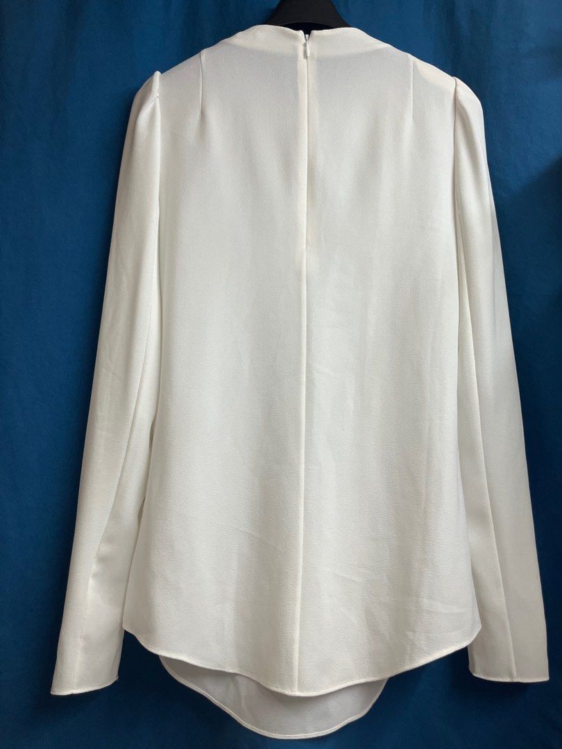Carven White Longsleeve Blouse/Top (Category: Blouses) located in Quezon City. Submitted by wednesday21 (Listing ID 1333215280, Image 2). Description: Carven white blouse with slightly puffed long sleeves. Crepe fabric with pleated design in front and concealed zipper at the back..
