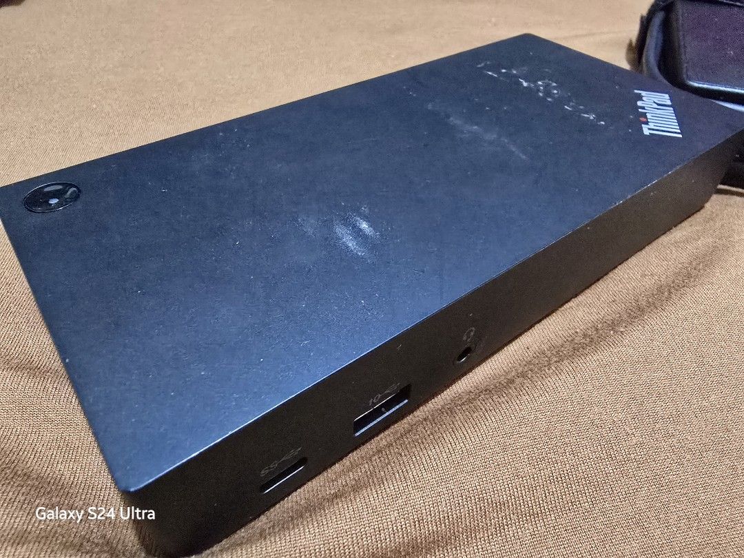 For Sale: Lenovo Docking Station (Category: Laptops & Notebooks) located in Manila. Submitted by iamkimmyri77434 (Listing ID 1333177238, Image 3). Description: Model: See model number in the photo for compatibility (ensure compatibility with your device before purchase). Condition: Lightly used, fully functional, no defects. Minor hairline scratches and sticker marks from previous mounting, but these don’t affect performance. Includes: Docking st