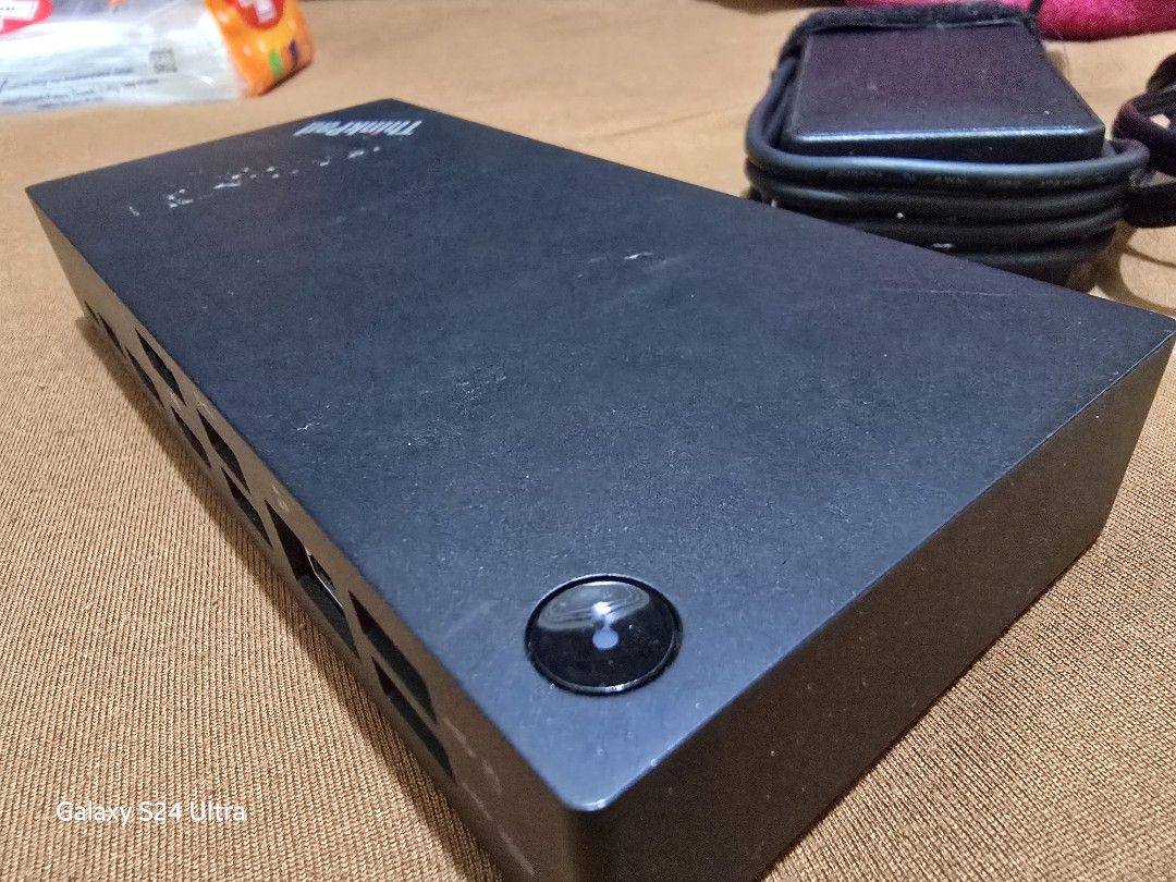 For Sale: Lenovo Docking Station (Category: Laptops & Notebooks) located in Manila. Submitted by iamkimmyri77434 (Listing ID 1333177238, Image 1). Description: Model: See model number in the photo for compatibility (ensure compatibility with your device before purchase). Condition: Lightly used, fully functional, no defects. Minor hairline scratches and sticker marks from previous mounting, but these don’t affect performance. Includes: Docking st