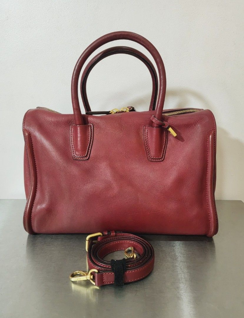 MCM Large Boston w/ Sling (Category: Luxury Bags & Wallets) located in Valenzuela. Submitted by absolutelychick (Listing ID 1333317995, Image 1). Description: L 14" x W 5.25" x H 9.5" meron pong madaming black pen mark at dumi sa inner lining (needs cleaning po sa loob) may light na fade po sa metal hardwares jrs, lbc, j&t lalamove/grab ready.
