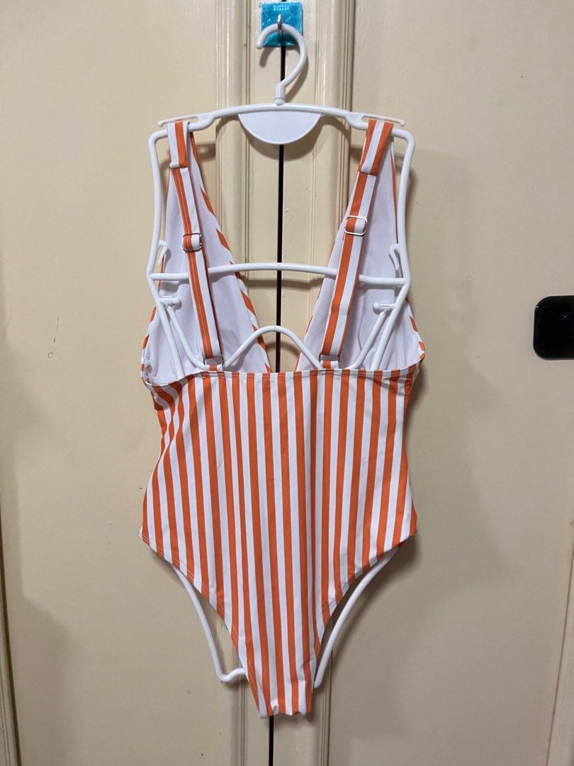 Shein Orange Stripe One Piece (Category: Bikinis & Swimsuits) located in Makati City. Submitted by frelbv (Listing ID 1333196961, Image 2). Description: Never used. No longer fits me Can be bought as 1000 with 3 other items priced 300.