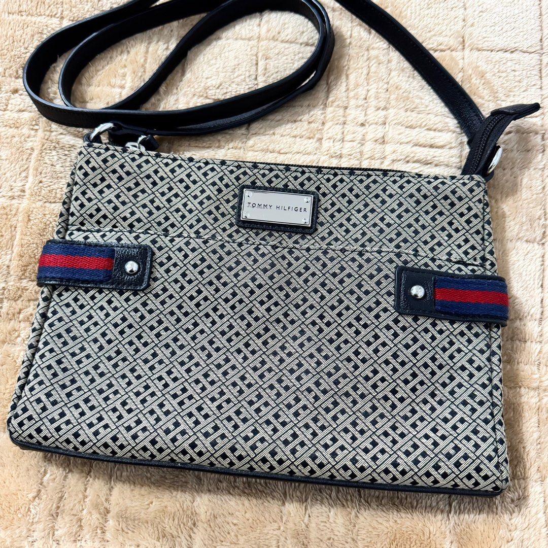 Tommy Hilfiger Crossbody Bag (Category: Cross-body Bags) located in Quezon City. Submitted by arkideclutters (Listing ID 1333442247, Image 3). Description: Canvas Clean interior Few noticeable hairlines on logo Few tarnished hardwares Intact rubber linning on straps and bottom part of the bag.