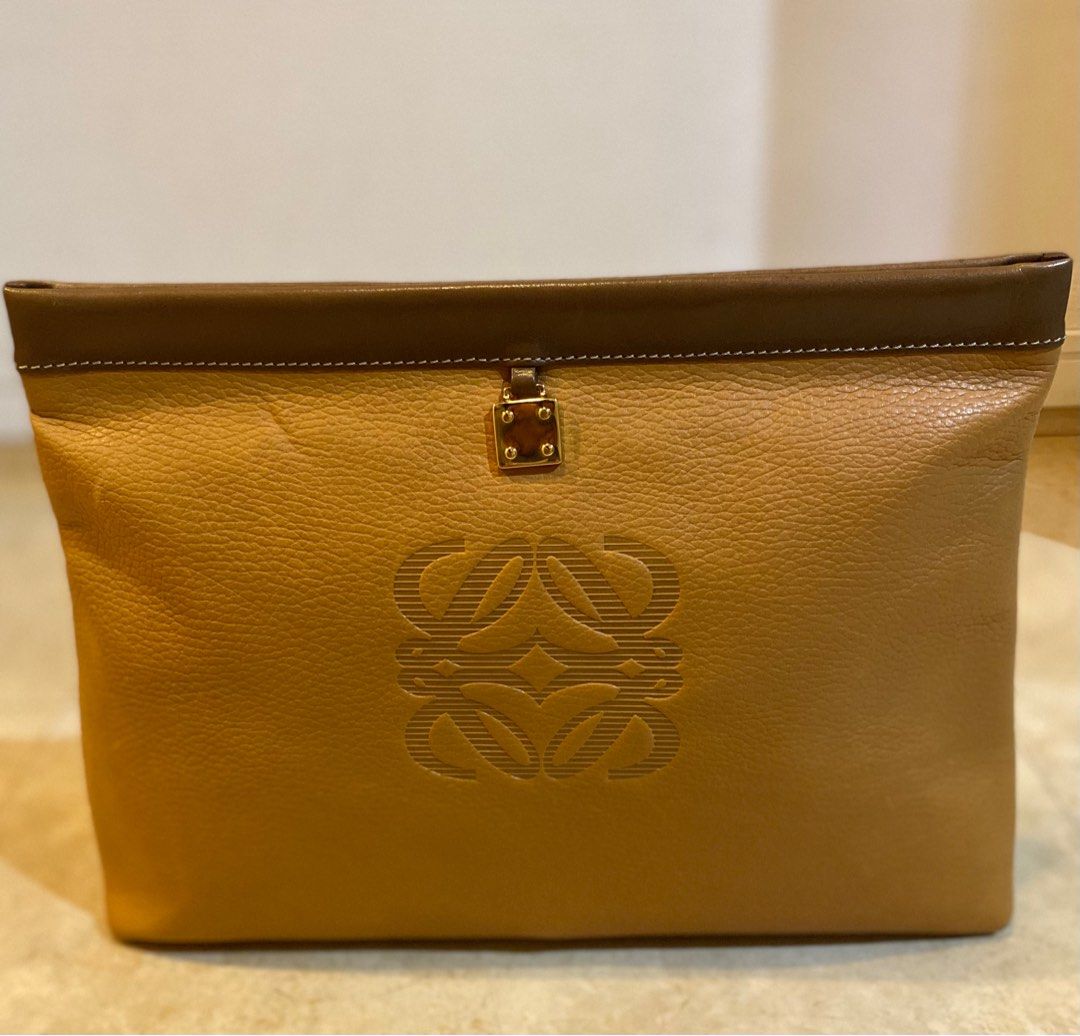 LOEWE Vintage Anagram Envelope Pouch (Category: Luxury Bags & Wallets) located in Manila. Submitted by lilyroseandlauretta (Listing ID 1328944896, Image 1). Description: LOEWE Vintage Anagram Embossed Envelope Pouch -pebbled leather -embossed logo -gold hardware -magnetic snap closure -cotton interior lining -dimension: 13 x 2.5 x 9.5 inches -made in Spain *NO INCLUSIONS *CONDITION vintage pre-owned good condition leather crease scrathes on the h