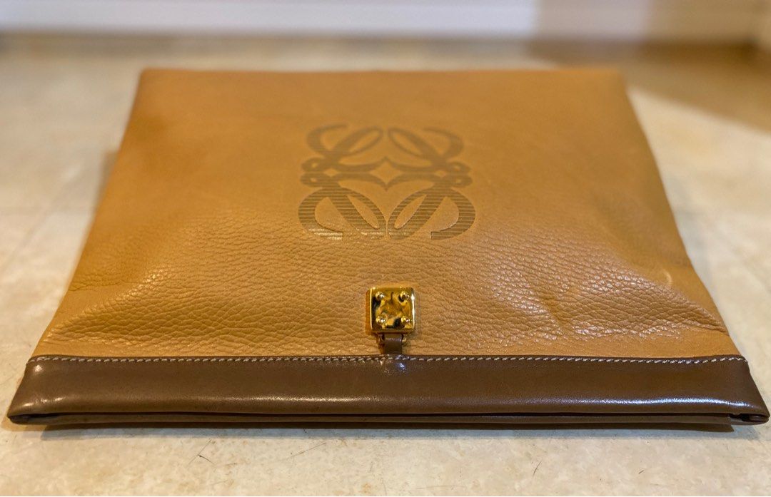 LOEWE Vintage Anagram Envelope Pouch (Category: Luxury Bags & Wallets) located in Manila. Submitted by lilyroseandlauretta (Listing ID 1328944896, Image 3). Description: LOEWE Vintage Anagram Embossed Envelope Pouch -pebbled leather -embossed logo -gold hardware -magnetic snap closure -cotton interior lining -dimension: 13 x 2.5 x 9.5 inches -made in Spain *NO INCLUSIONS *CONDITION vintage pre-owned good condition leather crease scrathes on the h