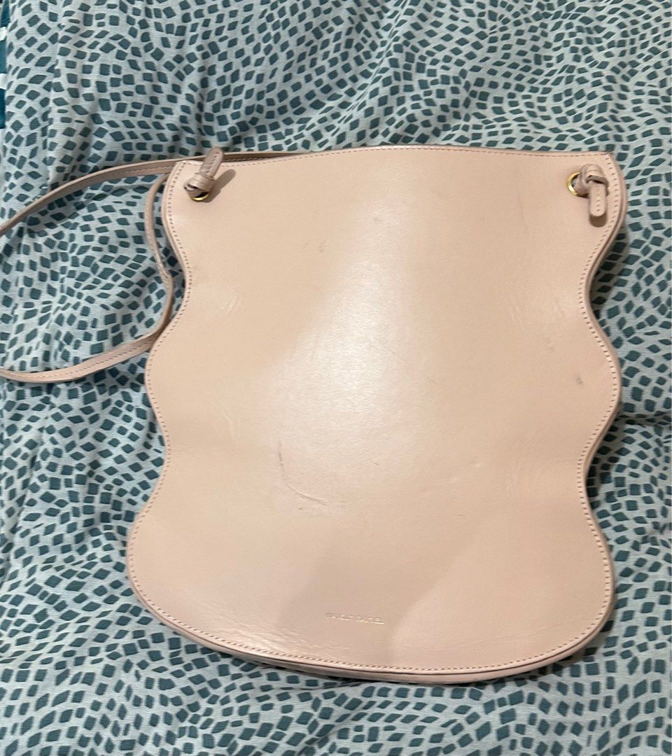Mansur Gavriel Ocean Tote (Category: Luxury Bags & Wallets) located in Los Banos. Submitted by jeremiah31.3 (Listing ID 1328875970, Image 1). Description: In light peach color and still in very good used condition. Has some scratches and light stains but barely noticeable when worn. A bag with a minimalist yet stylish vibe. A statement bag indeed!.