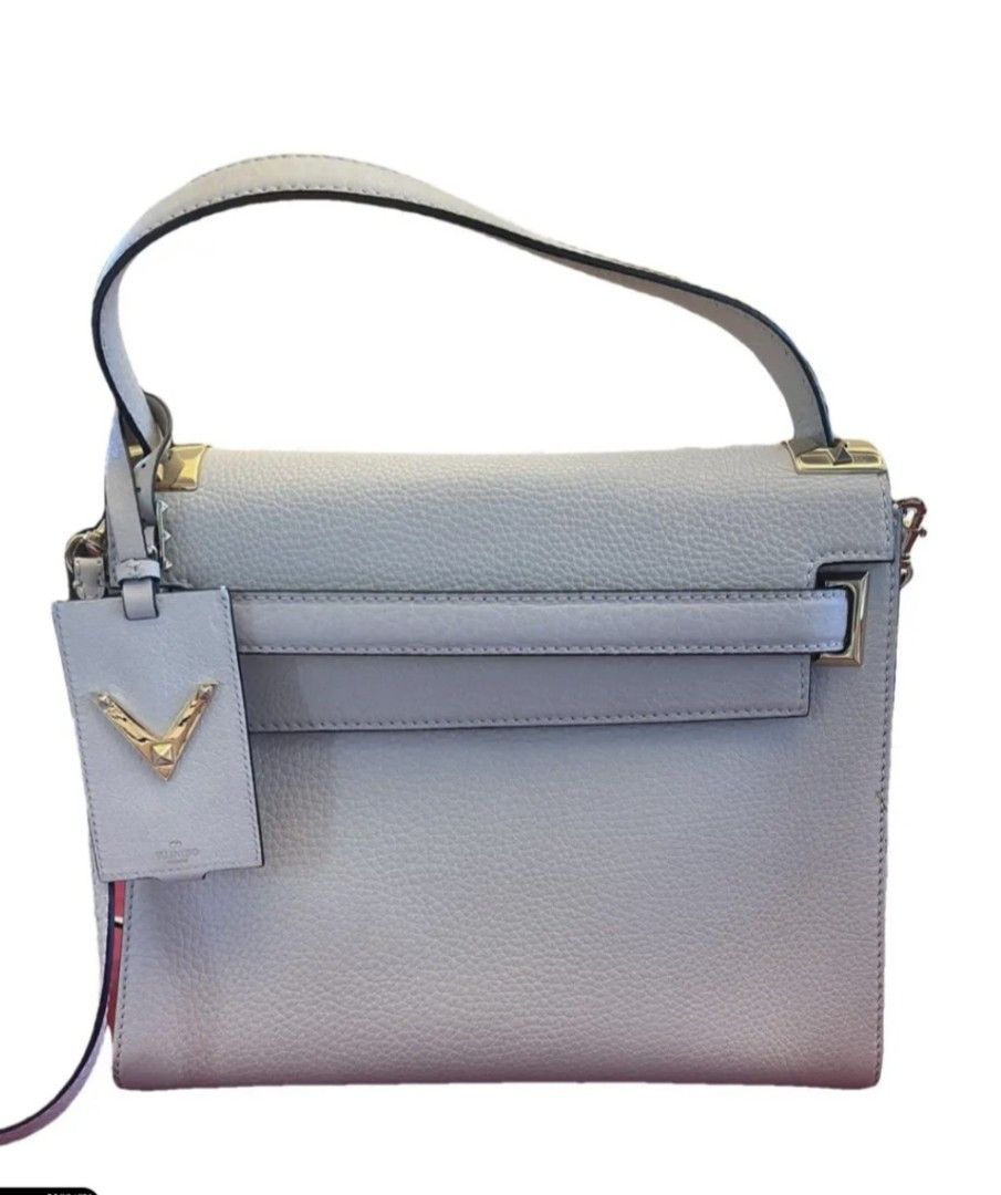 Valentino Garavani (Category: Bags & Wallets) located in Singapore. Submitted by kathyleo (Listing ID 1328783229, Image 1). Description: This Valentino leather My Rockstud bag is held by a single handle, as well as a removable shoulder strap, and equipped with a spacious interior. A small dot of press on the front and back of the bag. Sold with dustbag.