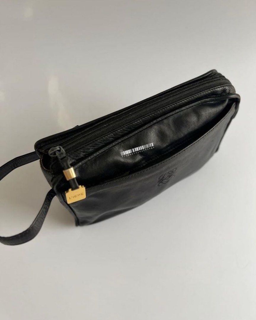 LOEWE Vintage Anagram Pebbled Clutch (Category: Luxury Bags & Wallets) located in Cavite. Submitted by frommetoyouthings (Listing ID 1333847482, Image 3). Description: - Well used but still in very good vintage condition - Spacious and can fit a lot of things including iPhone Pro Max or a pocket book/notebook. - Flaws: corner/lining rubs, zipper hardware peeling and tarnish, hairline scratches on Loewe gold hardware - includes original dustbag.