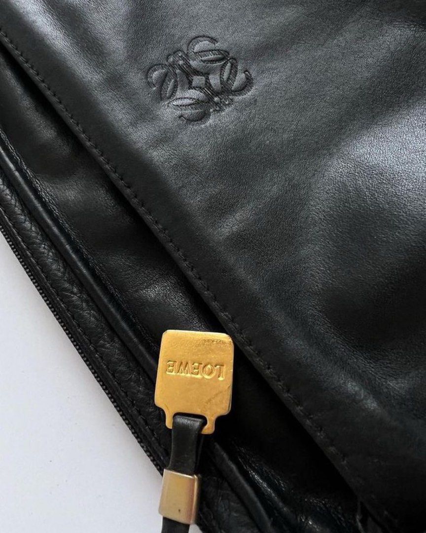 LOEWE Vintage Anagram Pebbled Clutch (Category: Luxury Bags & Wallets) located in Cavite. Submitted by frommetoyouthings (Listing ID 1333847482, Image 1). Description: - Well used but still in very good vintage condition - Spacious and can fit a lot of things including iPhone Pro Max or a pocket book/notebook. - Flaws: corner/lining rubs, zipper hardware peeling and tarnish, hairline scratches on Loewe gold hardware - includes original dustbag.
