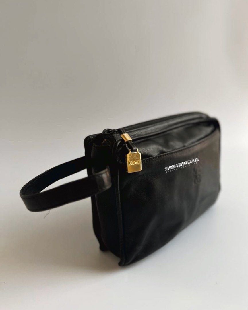 LOEWE Vintage Anagram Pebbled Clutch (Category: Luxury Bags & Wallets) located in Cavite. Submitted by frommetoyouthings (Listing ID 1333847482, Image 2). Description: - Well used but still in very good vintage condition - Spacious and can fit a lot of things including iPhone Pro Max or a pocket book/notebook. - Flaws: corner/lining rubs, zipper hardware peeling and tarnish, hairline scratches on Loewe gold hardware - includes original dustbag.