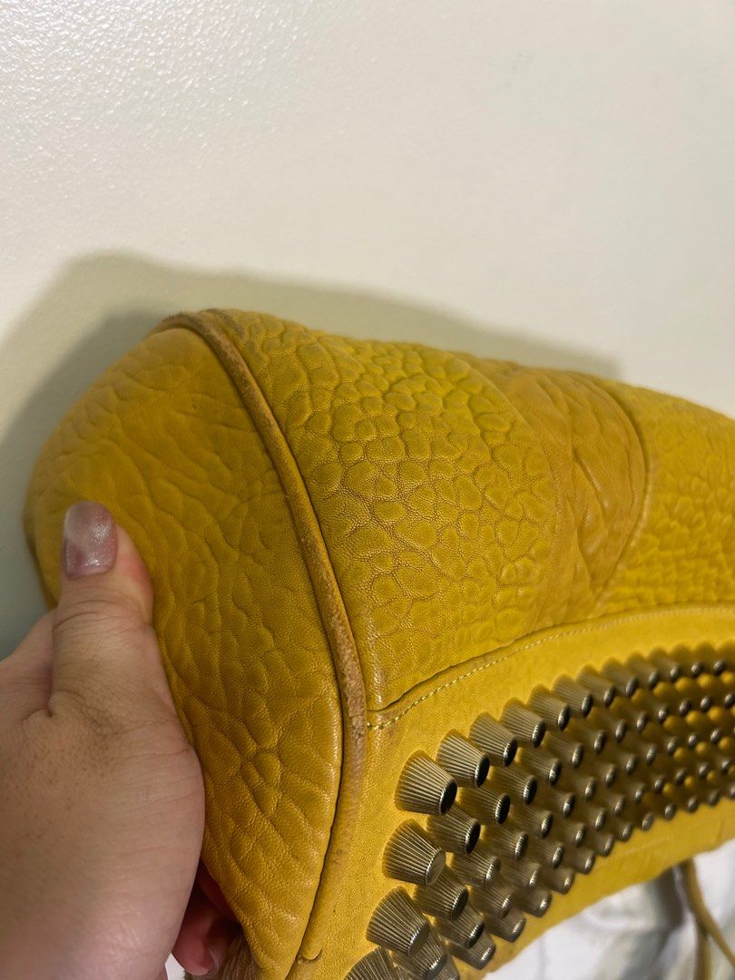 RARE 💗 Alexander Mcqueen Speedy (Category: Luxury Bags & Wallets) located in Quezon City. Submitted by she-ann (Listing ID 1328968649, Image 3). Description: Authentic Alexander Wang speedy Bag PLEASE READ: 32cm base x 25cm height (roughly) 2 way bag Mustard yellow in color (medyo madumi na lang pero pwede naman malinisan) Gender friendly Siper nice in person May weight guys kasi mabigat yung mga metal sa ilalim Very spacious Soft leather Flaw: 