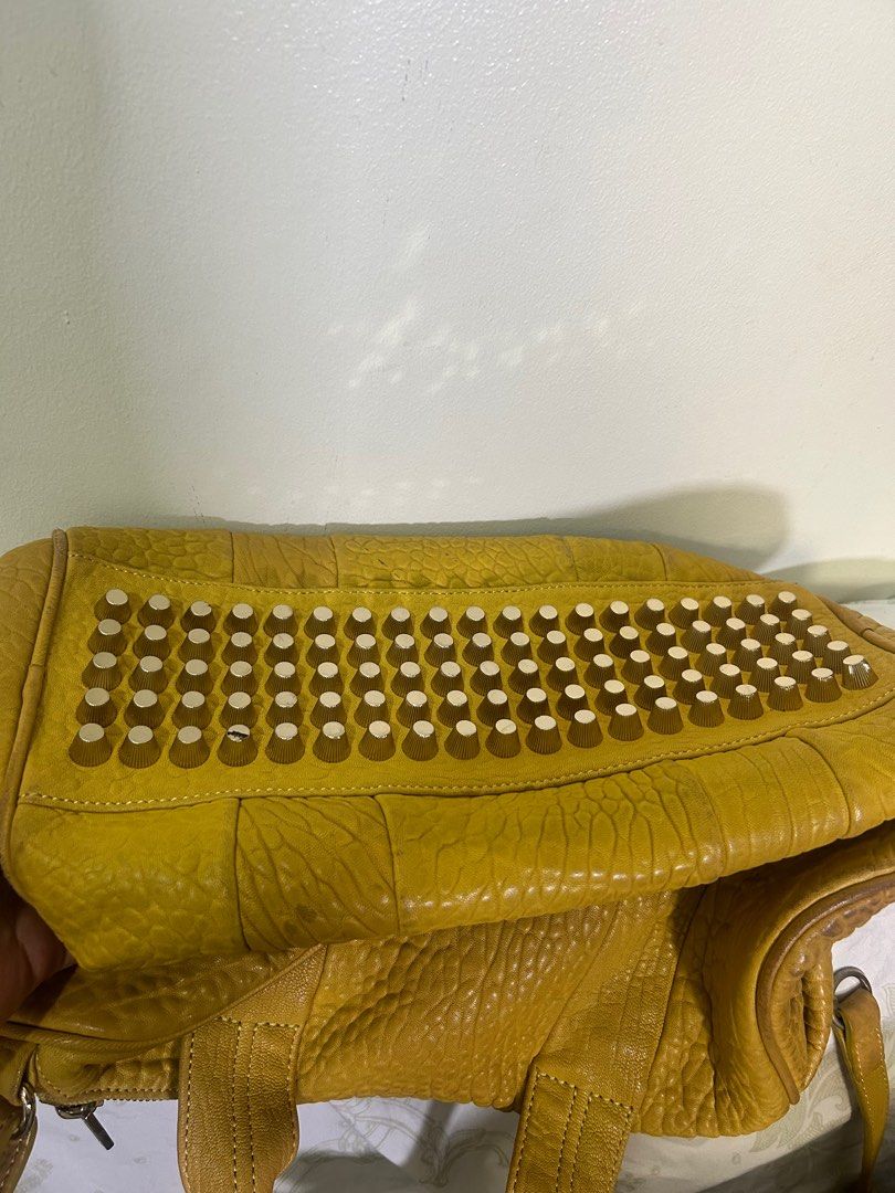 RARE 💗 Alexander Mcqueen Speedy (Category: Luxury Bags & Wallets) located in Quezon City. Submitted by she-ann (Listing ID 1328968649, Image 2). Description: Authentic Alexander Wang speedy Bag PLEASE READ: 32cm base x 25cm height (roughly) 2 way bag Mustard yellow in color (medyo madumi na lang pero pwede naman malinisan) Gender friendly Siper nice in person May weight guys kasi mabigat yung mga metal sa ilalim Very spacious Soft leather Flaw: 