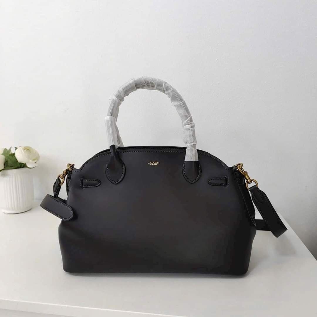 Coach Empire Carryall Bag 28 Black (Category: Tote Bags) located in Manila. Submitted by stacey_lopez922 (Listing ID 1328989542, Image 3). Description: Coach Empire Carryall Bag 28 Black (With dustbag and paperbag) - 35.5cm (L) x 21.5cm (H) x 16cm (W) - Glovetanned leather - Inside snap pocket - Center zip compartment - Fabric lining - Handles with 9.5cm drop - Detachable strap with 54.5cm drop for shoulder or crossbody wear - Four protective fee
