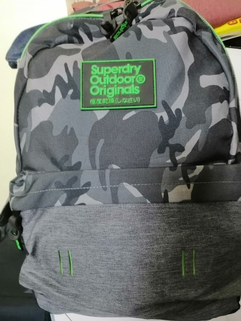 Superdry backpack (Category: Backpacks) located in Quezon City. Submitted by annyeong9 (Listing ID 1329001362, Image 1). Description: Superdry backpack camouflaged moss green. Small to medium size. Original from Japan. P1, 500.00. With very minimal flaws but hardly seen. Just sign of usage. For school or office daily use. Pang Gen Z to A. 😁😂🙏🤭. PM for details and price..