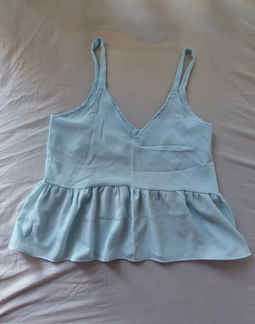 Sky Blue Sleeveless Peplum Top (Category: Sleeveless) located in Makati City. Submitted by allyrchives (Listing ID 1329211220, Image 1). Description: Sky Blue Sleeveless Peplum Top L: 21 in B: 33 - 34 in - soft light fabric - better layered on top of a shirt rfs: decluttering.