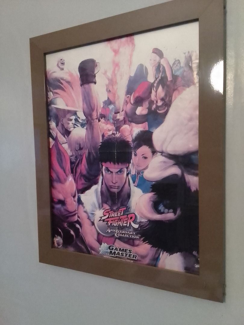 STREET FIGHTER ANNIVERSARY COLLECTION POSTER (FRAMED) (Category: Art & Prints) located in Mandaluyong City. Submitted by neko.neko21 (Listing ID 1329525963, Image 2). Description: SIZE : 19.5 X 25 (FRAME INCLUDED) FORMAT : POSTER REMARK : - POSTER FROM GAME MASTER'S MAGAZINE - WITH FOLD - POSTER FRAMED WITH ANONIZED METAL (SAND BROWN) AND GLASS PAYMENT METHOD - BDO - BANK OF COMMERCE - G CASH - CASH (on pick up) * PICK UP - PICK UP - Talia Bldg. 