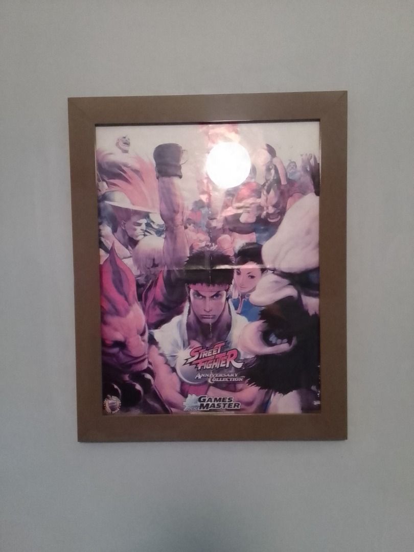 STREET FIGHTER ANNIVERSARY COLLECTION POSTER (FRAMED) (Category: Art & Prints) located in Mandaluyong City. Submitted by neko.neko21 (Listing ID 1329525963, Image 1). Description: SIZE : 19.5 X 25 (FRAME INCLUDED) FORMAT : POSTER REMARK : - POSTER FROM GAME MASTER'S MAGAZINE - WITH FOLD - POSTER FRAMED WITH ANONIZED METAL (SAND BROWN) AND GLASS PAYMENT METHOD - BDO - BANK OF COMMERCE - G CASH - CASH (on pick up) * PICK UP - PICK UP - Talia Bldg. 