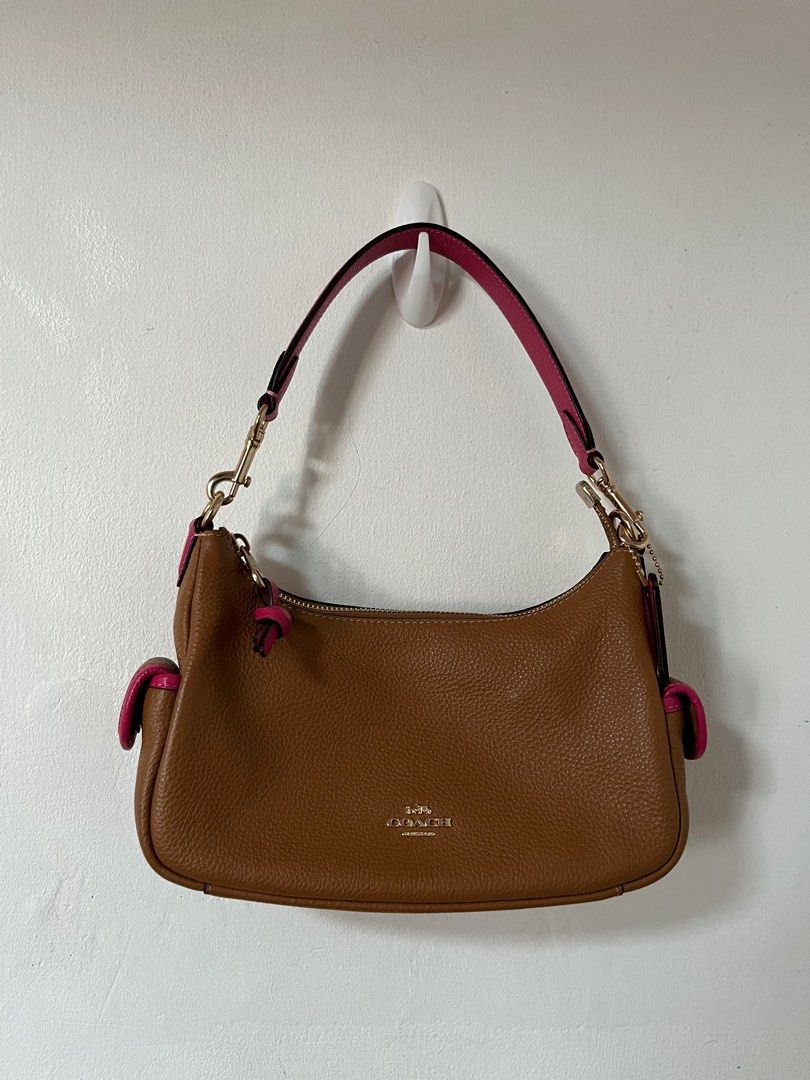 Coach Purse (Category: Luxury Bags & Wallets) located in Manila. Submitted by ashanti2002 (Listing ID 1329906829, Image 1). Description: RS: Coach Pennie Shoulder Bag - Brown/Pink Original Price: ₱15k Price is negotiable In good condition! (There is a small scratch on the pink coach tag but it’s unnoticeable) .