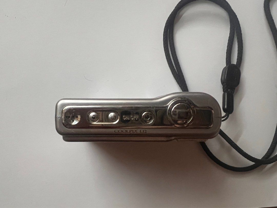 Nikon L12 - FOR REPAIR - DIGICAM (Category: Cameras) located in Manila. Submitted by bwakbwak (Listing ID 1335532464, Image 3). Description: - 2nd hand condition (has few scratches) - FOR REPAIR - kinargahan ng battery tapos di natanggal ng ilang months causing the leak (check 5th photo) - no time to get it repaired myself kayo na lang. NO RETURN & REFUND. BUY AT YOUR OWN RISK! .