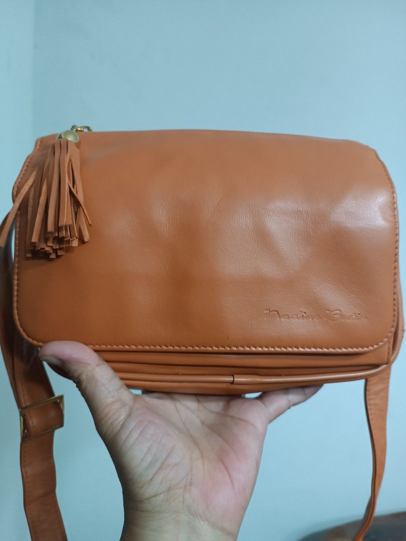 Nadine Buttin leather bag like new condition (Category: Cross-body Bags) located in San Fernando. Submitted by leezhine (Listing ID 1335751135, Image 1). Description: Like new condition leather sling bag. Brand: Nadia Buttin with lots of pockets, very nice in actual, clean inside and out no flaw still new.Can fit long wallet and a lot more, with inner card slots and detachable pockets. Size in inches: 9x3x8..