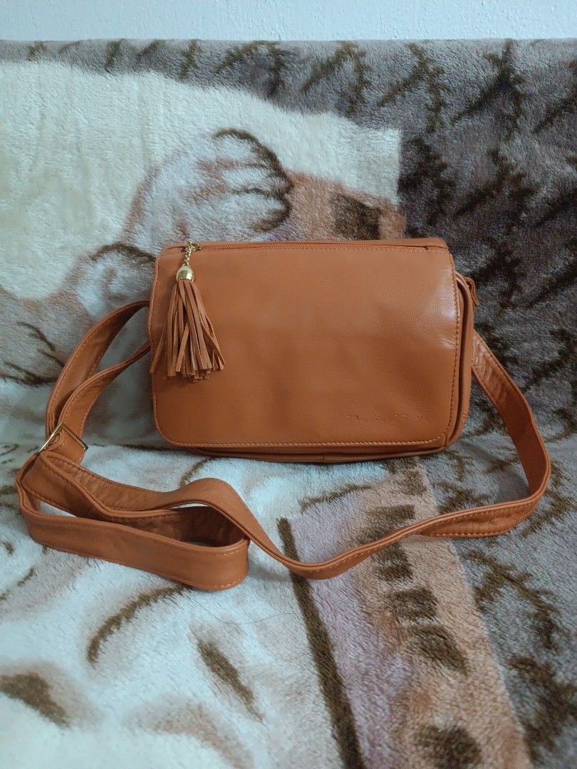 Nadine Buttin leather bag like new condition (Category: Cross-body Bags) located in San Fernando. Submitted by leezhine (Listing ID 1335751135, Image 2). Description: Like new condition leather sling bag. Brand: Nadia Buttin with lots of pockets, very nice in actual, clean inside and out no flaw still new.Can fit long wallet and a lot more, with inner card slots and detachable pockets. Size in inches: 9x3x8..