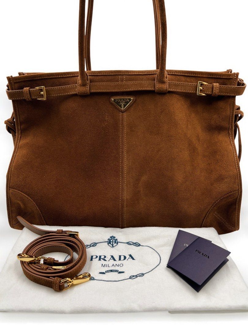 ⚜️Prada Suede Hand bag (Category: Luxury Bags & Wallets) located in Makati City. Submitted by 90sangel (Listing ID 1335771282, Image 2). Description: •Item: Prada Suede Hand bag 🤎⚜️ •Size: Large 24cm x 38cm •Condition: Excellent! no issues 👜 *Spacious and versatile design ~ *Features elegant straps, comes with a detachable, adjustable shoulder strap ~ .