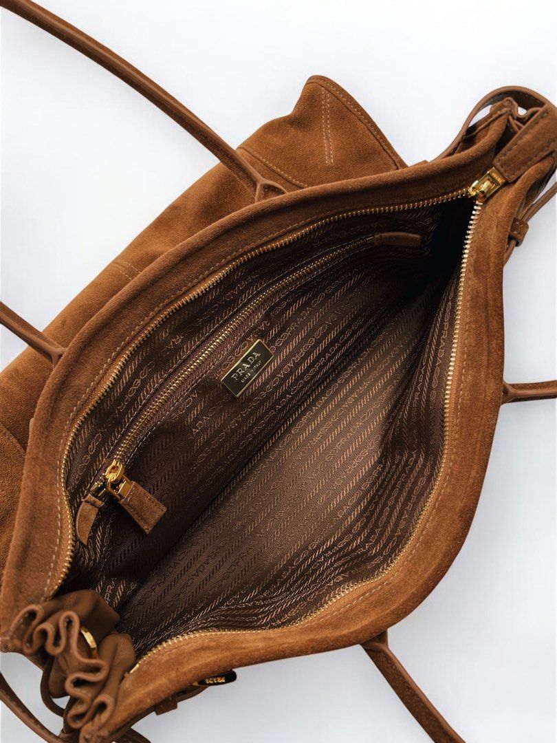 ⚜️Prada Suede Hand bag (Category: Luxury Bags & Wallets) located in Makati City. Submitted by 90sangel (Listing ID 1335771282, Image 3). Description: •Item: Prada Suede Hand bag 🤎⚜️ •Size: Large 24cm x 38cm •Condition: Excellent! no issues 👜 *Spacious and versatile design ~ *Features elegant straps, comes with a detachable, adjustable shoulder strap ~ .