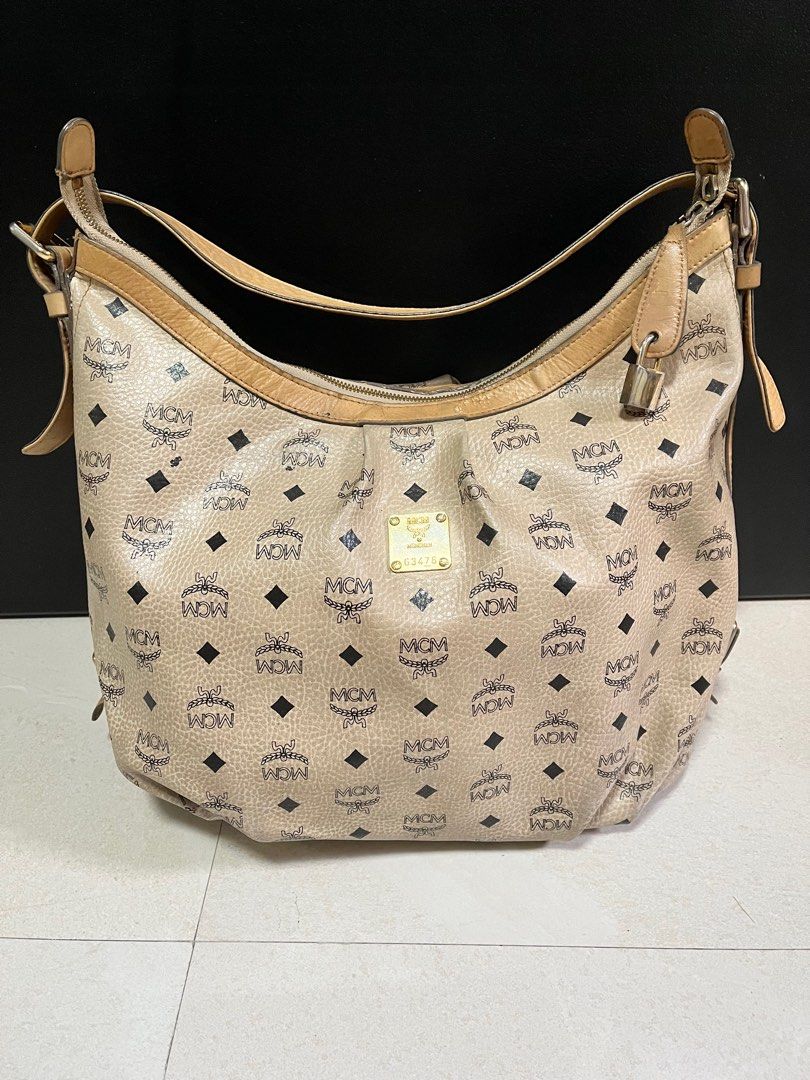 Authentic MCM Hobo Beige Visetos Leather Canvass Bag (Category: Luxury Bags & Wallets) located in Quezon City. Submitted by bebegaze (Listing ID 1335849955, Image 1). Description: Authentic With lock but no key One zipper puller missing With signs of use since preloved item like scratches, rubs, dirt etc. Please check all pics. .