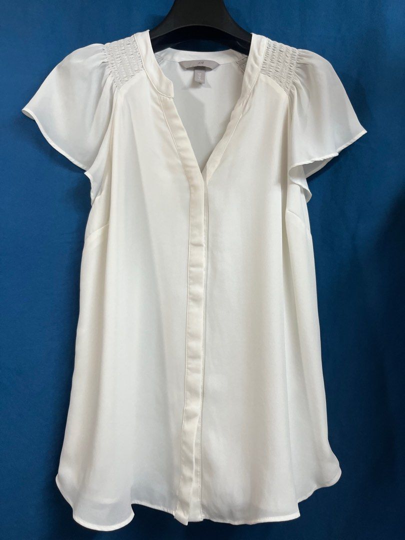 H&M Ivory White Buttondown Flutter Sleeves Top (Category: Blouses) located in Quezon City. Submitted by wednesday21 (Listing ID 1335858213, Image 1). Description: H&M ivory white flutter sleeve top. V-neck and button-down front. With short flutter sleeves and slight gathered/ruching detail at the shoulders. Semi-sheer and lightweight fabric. Relaxed fit. Size S. 3-day reservation only. Once offer is accepted, payment is expected to be made within