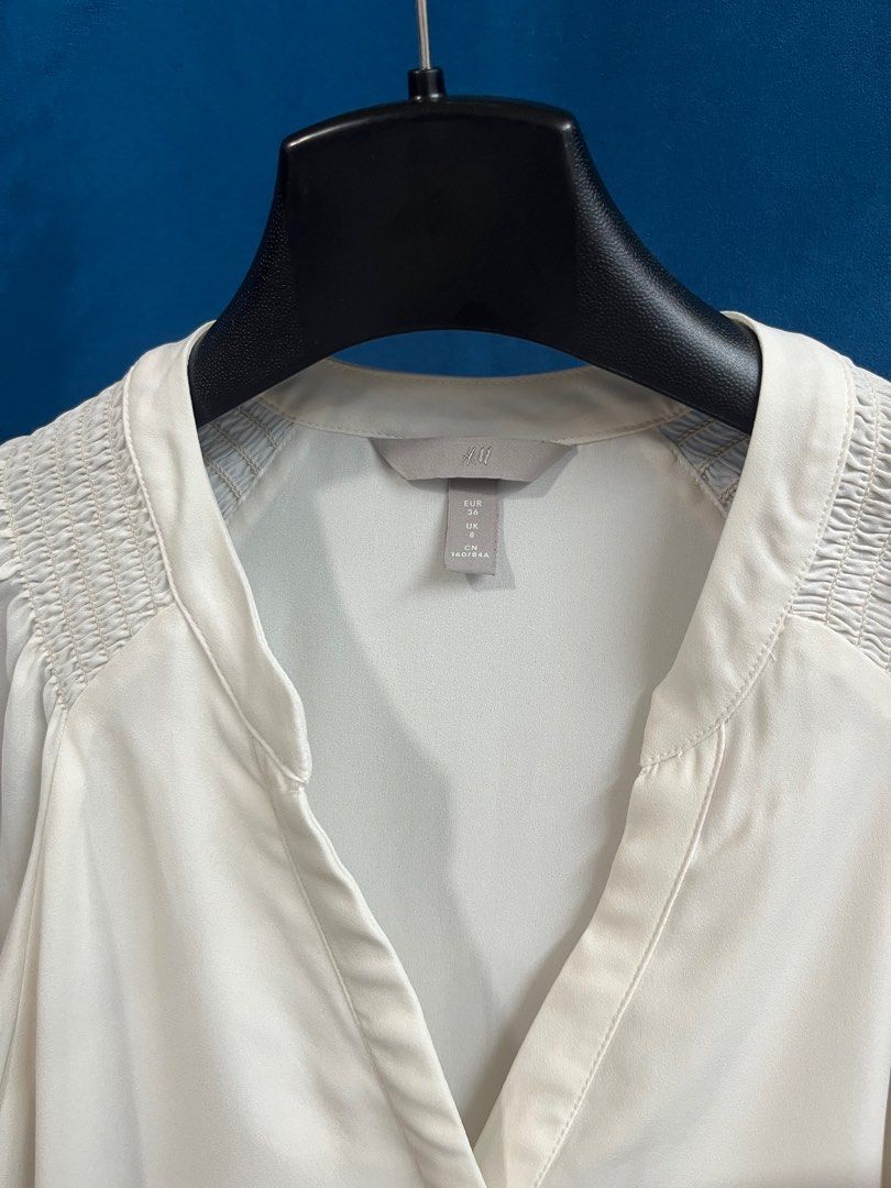 H&M Ivory White Buttondown Flutter Sleeves Top (Category: Blouses) located in Quezon City. Submitted by wednesday21 (Listing ID 1335858213, Image 3). Description: H&M ivory white flutter sleeve top. V-neck and button-down front. With short flutter sleeves and slight gathered/ruching detail at the shoulders. Semi-sheer and lightweight fabric. Relaxed fit. Size S. 3-day reservation only. Once offer is accepted, payment is expected to be made within
