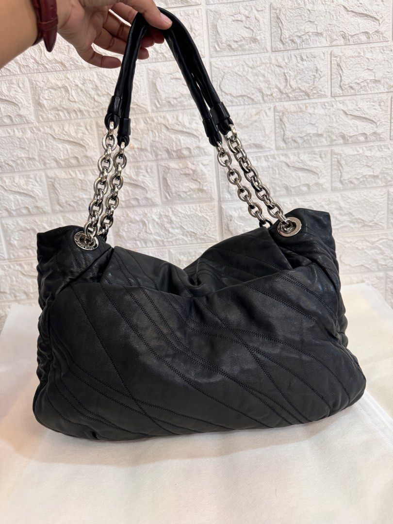 NINA RICCI Shoulder Leather Bag (Category: Luxury Bags & Wallets) located in Davao. Submitted by stellietas (Listing ID 1335937944, Image 3). Description: No flaws, excellent condition, looks new. Size: 16.5L X 11.5H x 5W inches Minimal scratches on the lock hardware, metal plate. Silver hardware Black Clean interior. Genuine leather, makapal and slightly may weight..