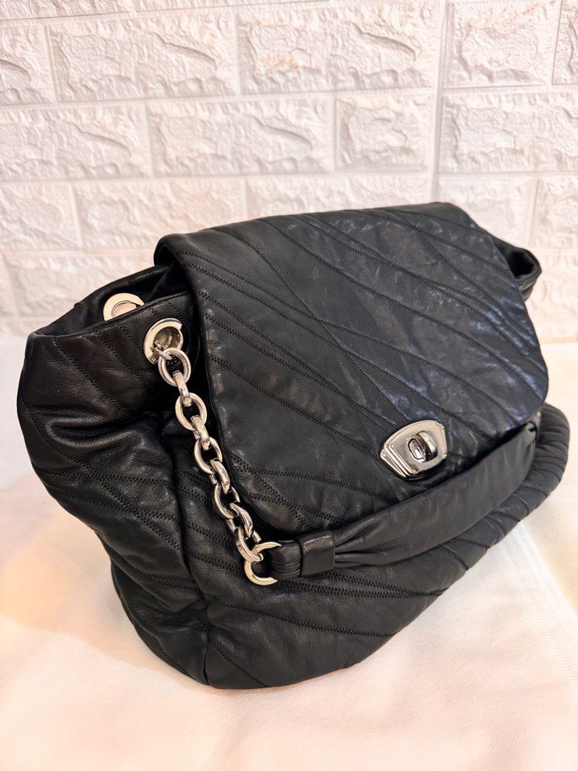 NINA RICCI Shoulder Leather Bag (Category: Luxury Bags & Wallets) located in Davao. Submitted by stellietas (Listing ID 1335937944, Image 2). Description: No flaws, excellent condition, looks new. Size: 16.5L X 11.5H x 5W inches Minimal scratches on the lock hardware, metal plate. Silver hardware Black Clean interior. Genuine leather, makapal and slightly may weight..