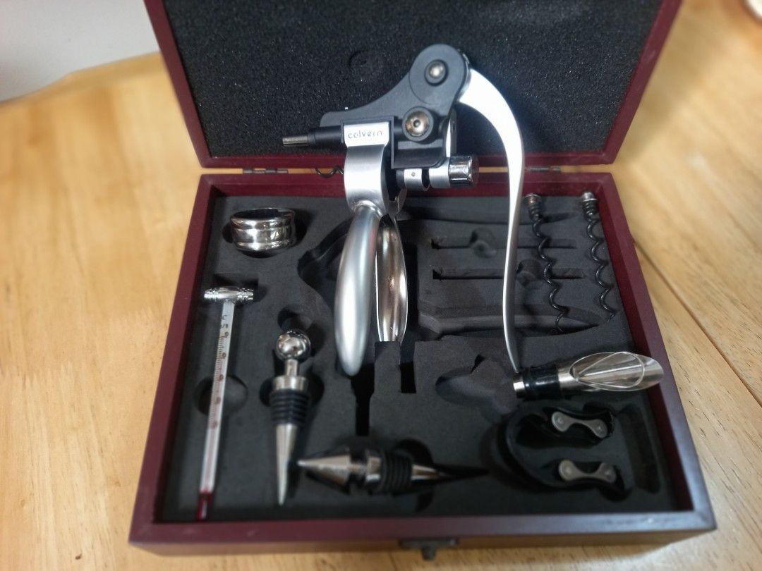 Wine - Corkscrew Set - Colvern Saphire Corkscrew Set (Category: Wine Cellar & Storage) located in Binan City. Submitted by graziosomoderato (Listing ID 1336044967, Image 3). Description: Corkscrew zinc alloy 2 wine stoppers - zinc alloy with rubber rings Wine thermometer made of glass with zinc alloy Pourer with stopper - stainless steel with silicone black part 2 spare corkscrews - made of metal teflon coating Foil cutter - made of plastic with 