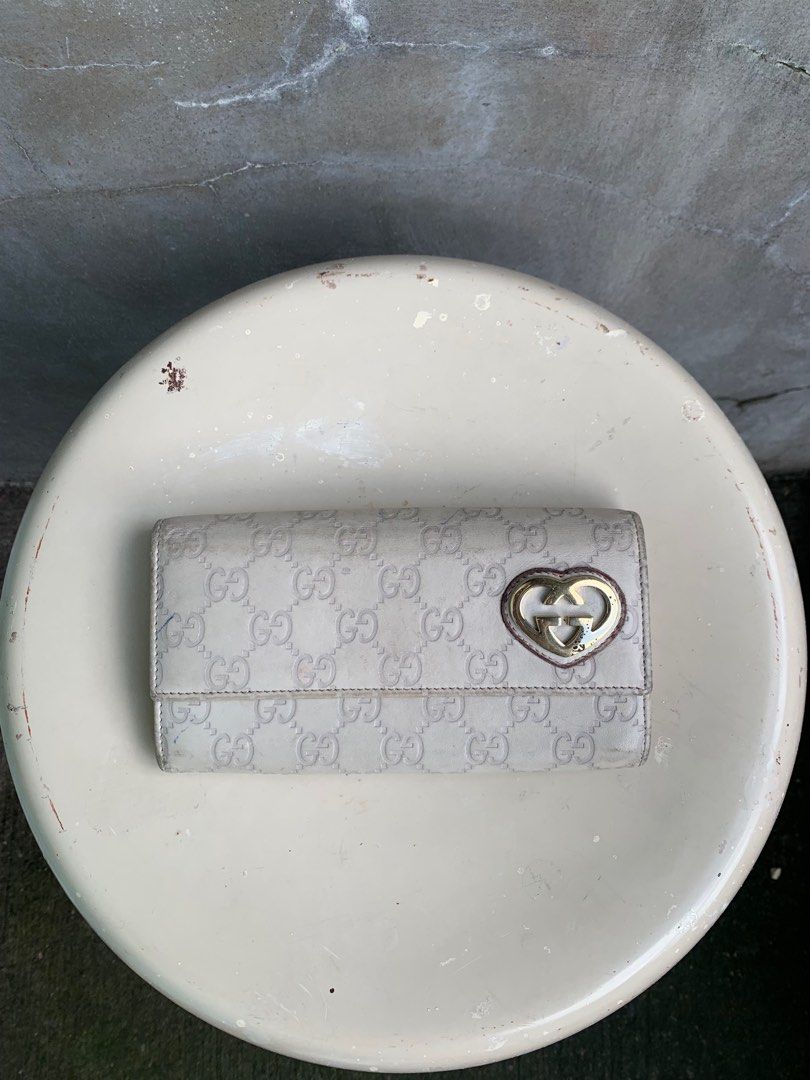 Gucci Guccissima Long Wallet (Category: Luxury Bags & Wallets) located in Baguio. Submitted by lordeidara (Listing ID 1336240220, Image 1). Description: Rank C Needs deep cleaning Stained Paint chip offs on hardware Color:Cream Material:,Leather Size on tag: Length:7.75 Width:1.5 Height:4.5 Strap Length: Number of Pockets:10.