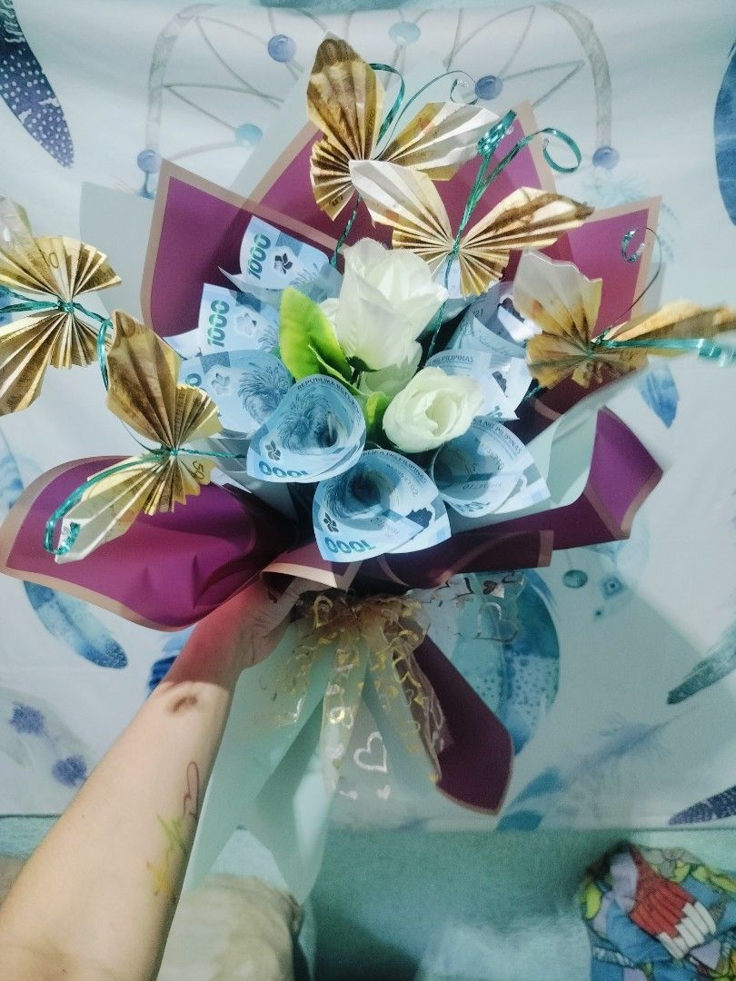 Money bouquet with butterflies (Category: Flowers & Bouquets) located in Antipolo. Submitted by blueshopvintage (Listing ID 1336202047, Image 2). Description: made to order money bouquet with moving butterflies design 🦋💸 15 slots/sticks (includes butterflies) + addtl plastic flowers (optional) plastic flower wrapper & ribbon/s 💸🦋deposit payment required upon order to push through making of money flowers& butterflies 2-3 days.rush order availa