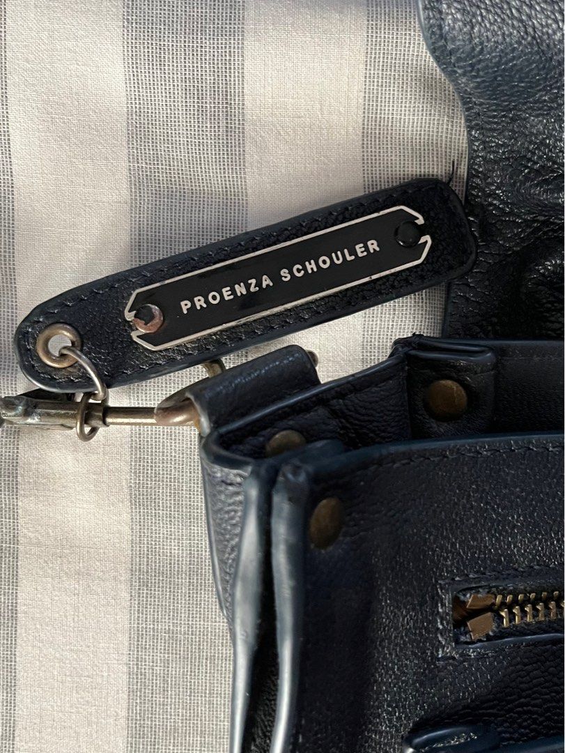 Proenza Schouler PS1 Medium Bag in Dark Navy (Category: Luxury Bags & Wallets) located in Paranaque City. Submitted by ___iroiro___ (Listing ID 1336386086, Image 2). Description: L: 12.5” D: 4” H: 8.5” Strap: 22” / 9” Drop RFS: Thrifted this with the hope that I could restore it. I do not have the time or the patience so would rather let go to someone who is willing to do it. Flaws: Missing knob to keep the bag closed. Because of this missing pie