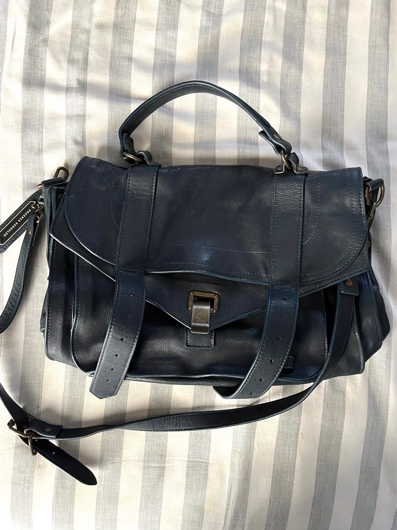 Proenza Schouler PS1 Medium Bag in Dark Navy (Category: Luxury Bags & Wallets) located in Paranaque City. Submitted by ___iroiro___ (Listing ID 1336386086, Image 1). Description: L: 12.5” D: 4” H: 8.5” Strap: 22” / 9” Drop RFS: Thrifted this with the hope that I could restore it. I do not have the time or the patience so would rather let go to someone who is willing to do it. Flaws: Missing knob to keep the bag closed. Because of this missing pie