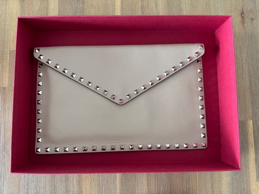 Valentino Rockstud Envelope Clutch (Category: Bags & Wallets) located in Singapore. Submitted by alisonyuen (Listing ID 1336351404, Image 1). Description: Large envelope clutch. Used only a few times. Comes with original box and extra studs but no dust bag. One tiny scuff mark as pictured. .