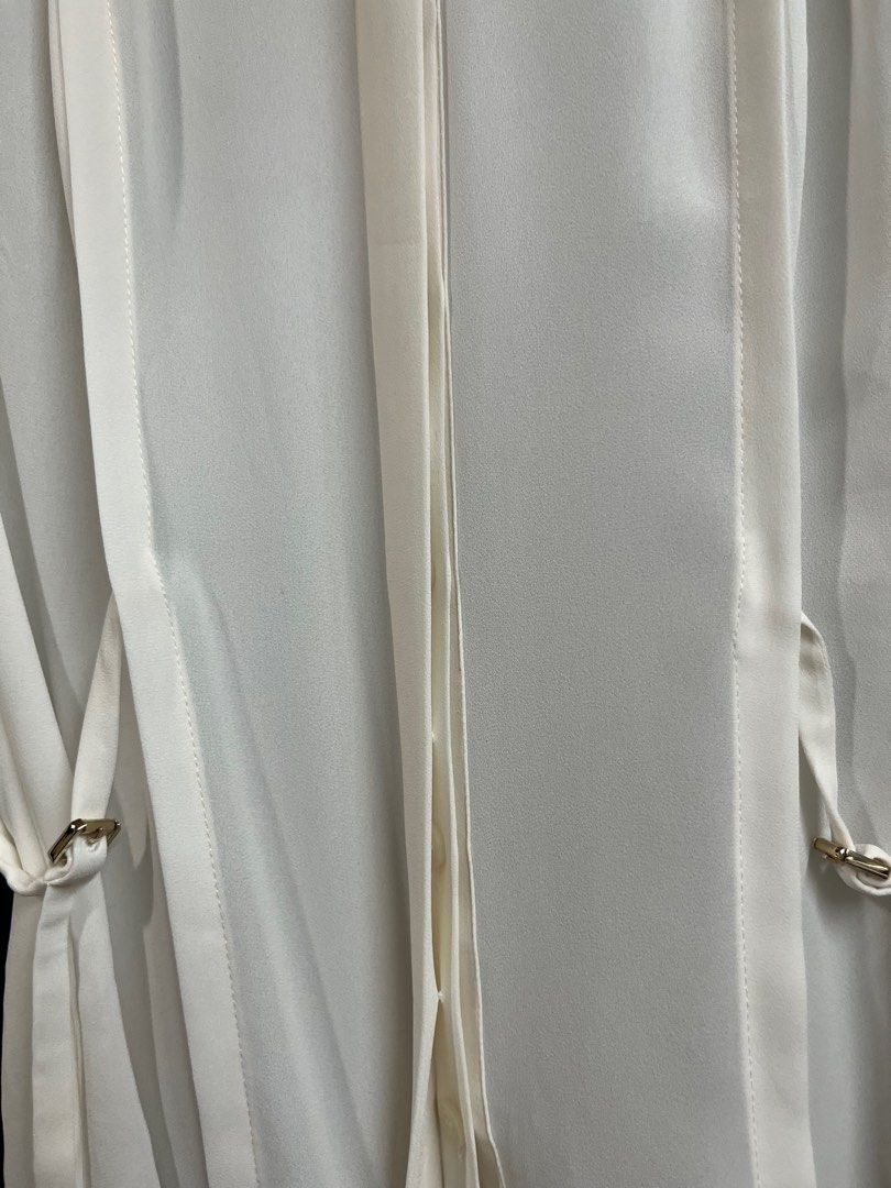 Karen Millen Cream Buttondown Collared Blouse (Category: Longsleeves) located in Quezon City. Submitted by wednesday21 (Listing ID 1336581302, Image 3). Description: Karen Millen cream buttondown collared longsleeve blouse, with concealed gold button placket and side-tie design with gold buckles. Gold button cuffs and foldable sleeves. Size XS on tag. Waist is 13in laid flat. 3-day reservation only. Once offer is accepted, payment is expected to 