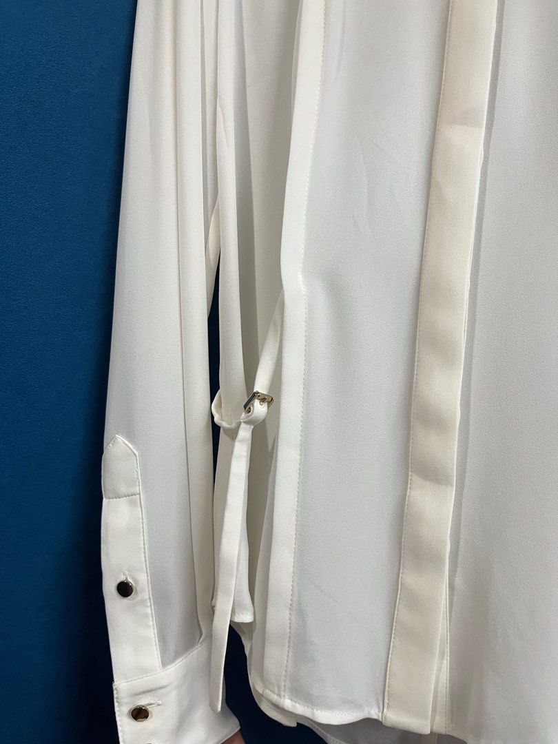 Karen Millen Cream Buttondown Collared Blouse (Category: Longsleeves) located in Quezon City. Submitted by wednesday21 (Listing ID 1336581302, Image 2). Description: Karen Millen cream buttondown collared longsleeve blouse, with concealed gold button placket and side-tie design with gold buckles. Gold button cuffs and foldable sleeves. Size XS on tag. Waist is 13in laid flat. 3-day reservation only. Once offer is accepted, payment is expected to 