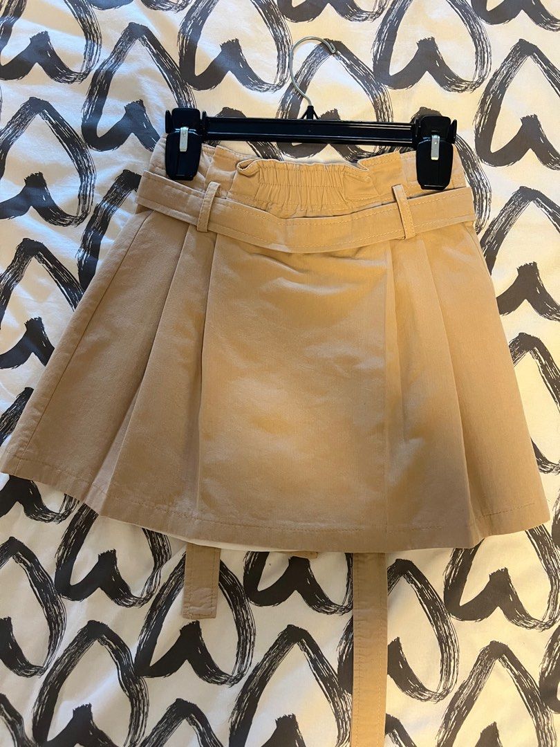KHAKI BROWN MINI TRENCH SKIRT (Category: Skirts) located in Manila. Submitted by declutterluxe (Listing ID 1336555810, Image 2). Description: Worn twice only Fits S-M frames My waist is 26-27” and can still stretch due to elasticized back Length 15.5” Working buttons Removable waist tie belt.