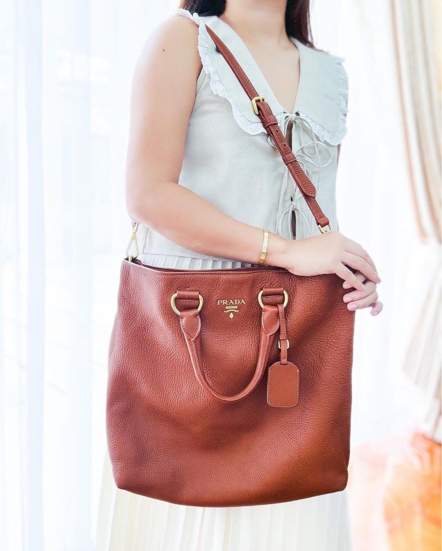 Authentic Pr@da Vitello Daino Two-Way Tote Bag (Category: Luxury Bags & Wallets) located in Quezon City. Submitted by jhaediah (Listing ID 1336726135, Image 1). Description: Authentic Pr@da Vitello Daino Two-Way Tote Bag Hardware: ghw Rank: A Size: Large Material: Calf leather Inclusions: long strap.