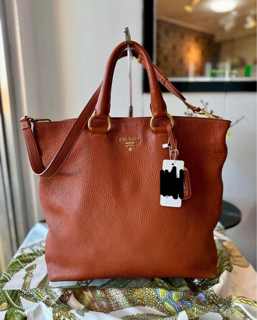 Authentic Pr@da Vitello Daino Two-Way Tote Bag (Category: Luxury Bags & Wallets) located in Quezon City. Submitted by jhaediah (Listing ID 1336726135, Image 2). Description: Authentic Pr@da Vitello Daino Two-Way Tote Bag Hardware: ghw Rank: A Size: Large Material: Calf leather Inclusions: long strap.