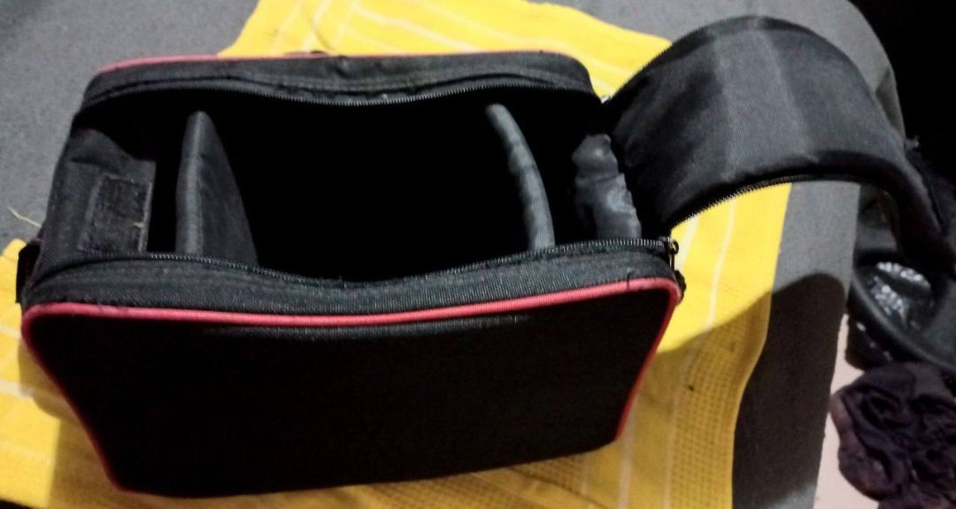 DSLR Camera Video Recorder Bag w/ Shoulder Strap (Category: Camera Bags & Carriers) located in Manila. Submitted by expatcollections (Listing ID 1336833212, Image 2). Description: CAMERA/VIDEO RECORDER bag with Adjustable Shoulder Strap Dimensions (L x W x H): 25 x 20 x 16 cms. Material & Color: Nylon Canvas Black with Red lining Brand & Condition: San-Ai Lightly used (RFS: Decluttering) .