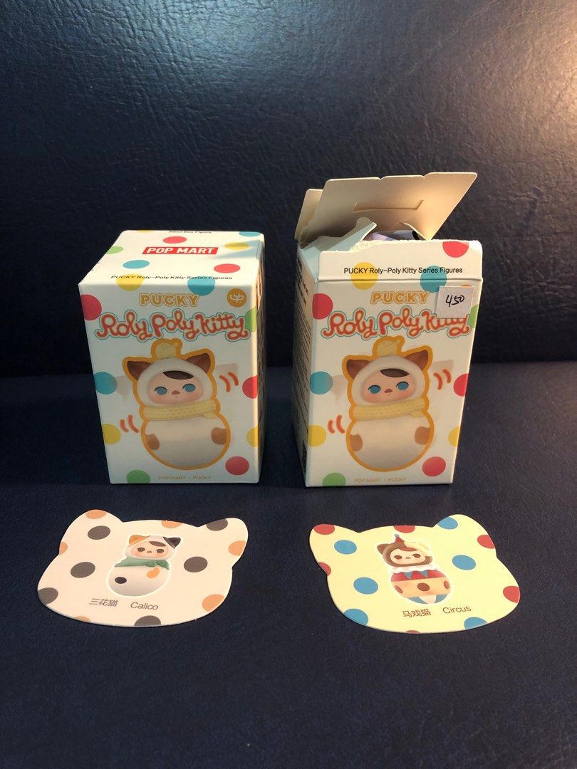 Pop Mart Pucky Roly Poly Kitty (Circus) (Category: Designer & Blind Box Toys) located in Pasig City. Submitted by maplemart (Listing ID 1336836000, Image 1). Description: RUSH: ONLY CIRCUS LEFT ₱300 Hi there! Selling my extra Pop Mart Pucky Roly Poly Kitty figures. I have Calico and Circus variants. Boxes and plastics are already opened. Calico was opened from the bottom, Circus from the top (please check pics). Immediately kept after opening. It