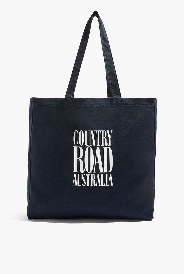 Country Road Australian Cotton CR Shopper Tote Bag (Navy) - RRP $49.95 (Category: Women's Bags & Wallets) located in Merrylands. Submitted by ferntwo1126455 (Listing ID 1337096986, Image 1). Description: Brand New- Country Road Australian Cotton CR Shopper Tote Bag (Navy) - RRP $49.95 The ultimate carry-all made using durable Australian cotton canvas, this versatile shopper features our statement logo print. H37cm x W38.5cm x D10.5cm Shoulder str